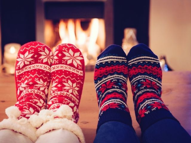 Christmas Shopping and budgeting tips with couple in ugly sweater socks