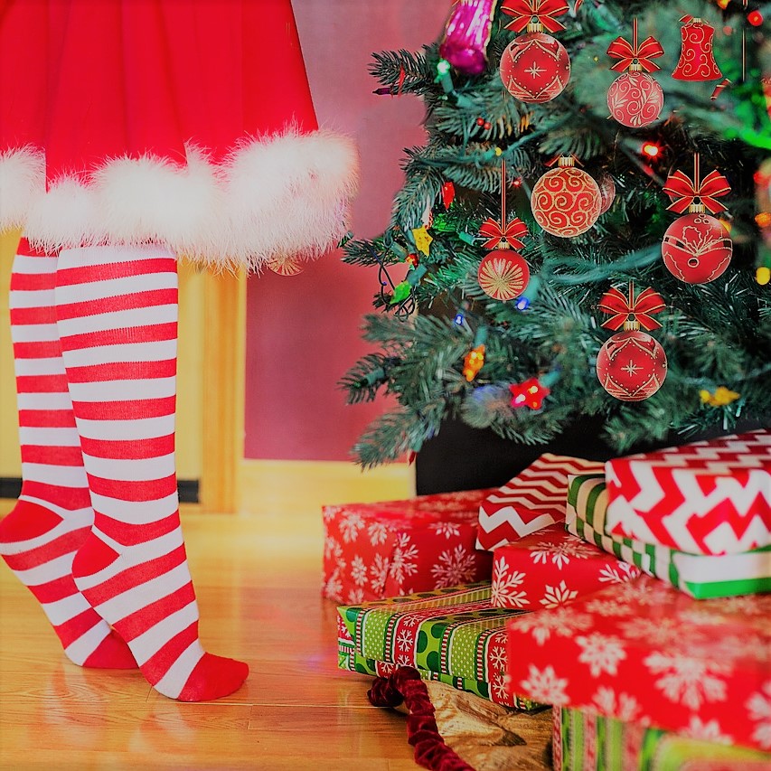 Saving and budget for the holidays. Christmas stockings by tree.