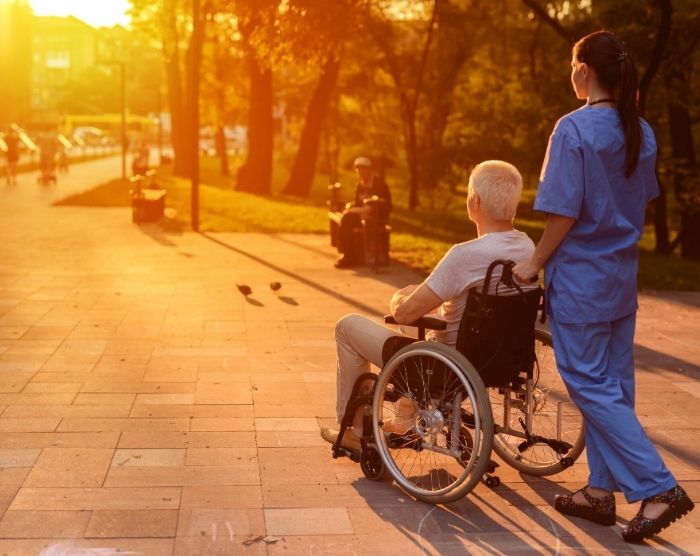 Where do nurses make the most money with lady pushing elderly man