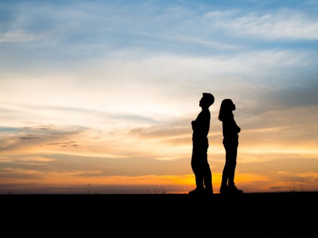 Divorce and Taxes with man and woman backs against each other
