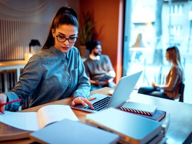 Tax Season Preparing understanding Tax Reform. A top tax tip with lady in front of laptop studying.