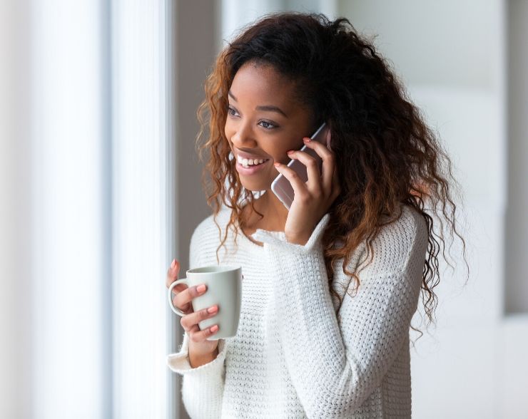 Lady in white sweater on the phone with IRS about Form 4883c Letter