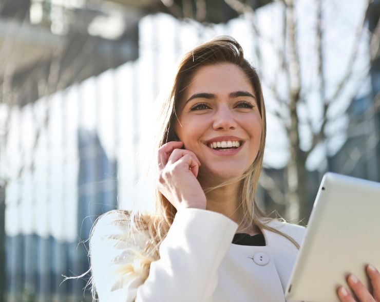 Woman happy about submitting IRS form 9465 for repayment plan on the phone