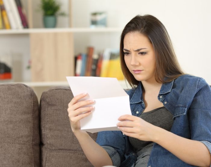 Lady looking a letter for
w2 form to calculate AGI