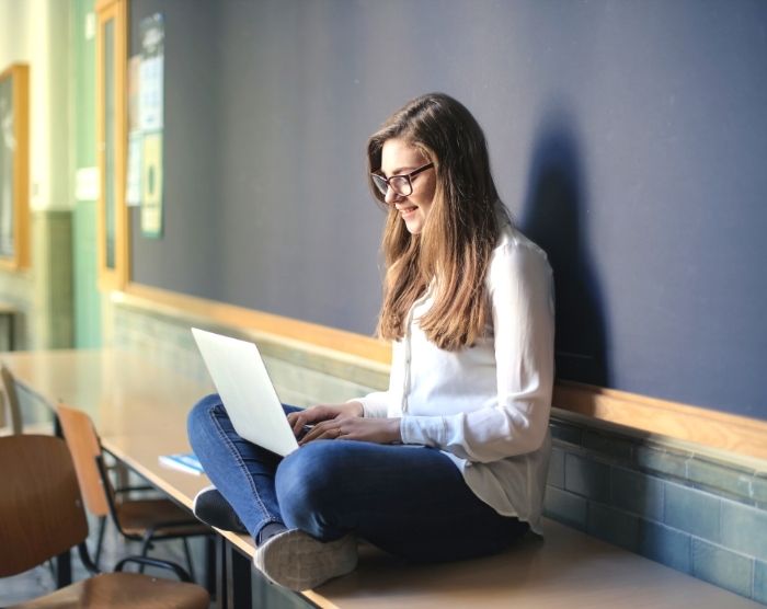 How to fill out IRS form 8863 with woman on laptop in college classroom