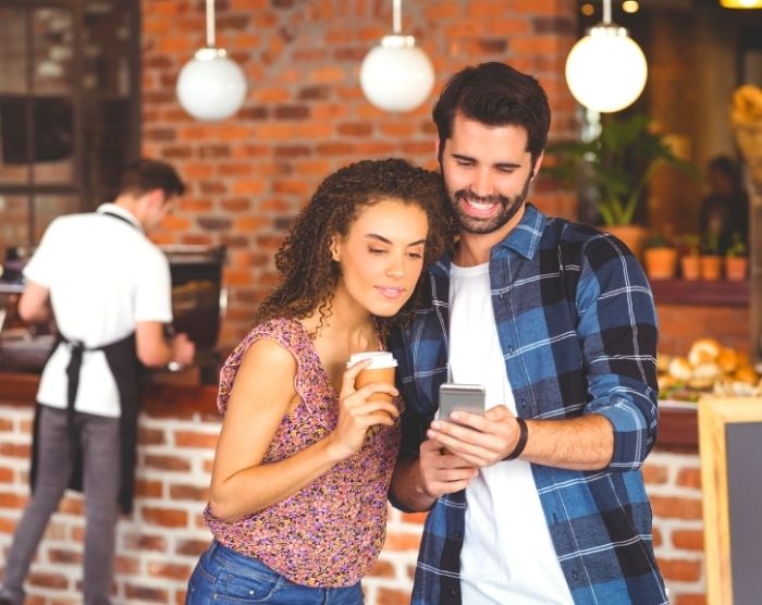 Hipster couple getting money saving tips.