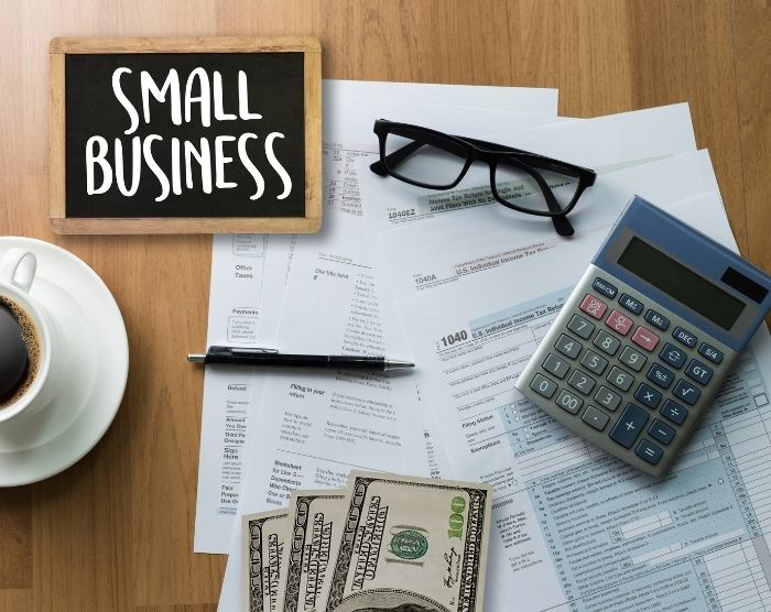 Small business owner with paper work everywhere registering for IRS form 2553