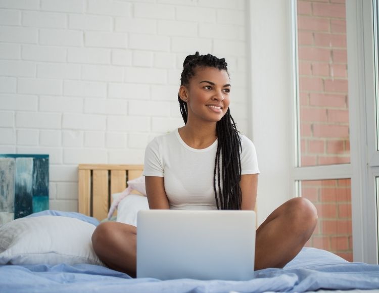Black young woman working on blog on computer