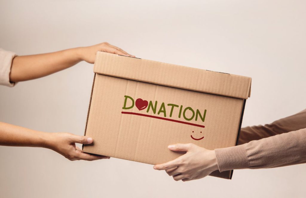 male and female holding a box of donations of taxable twitch donations