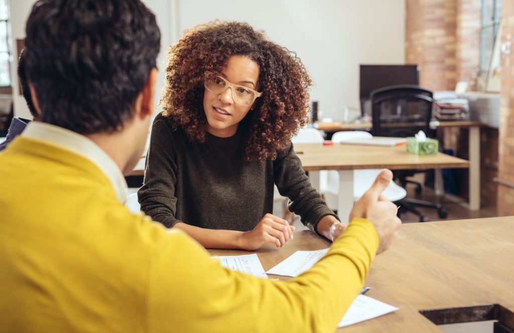 man and woman discussing financial situation and leaning what tax deductions are available for professionals in the beauty industry