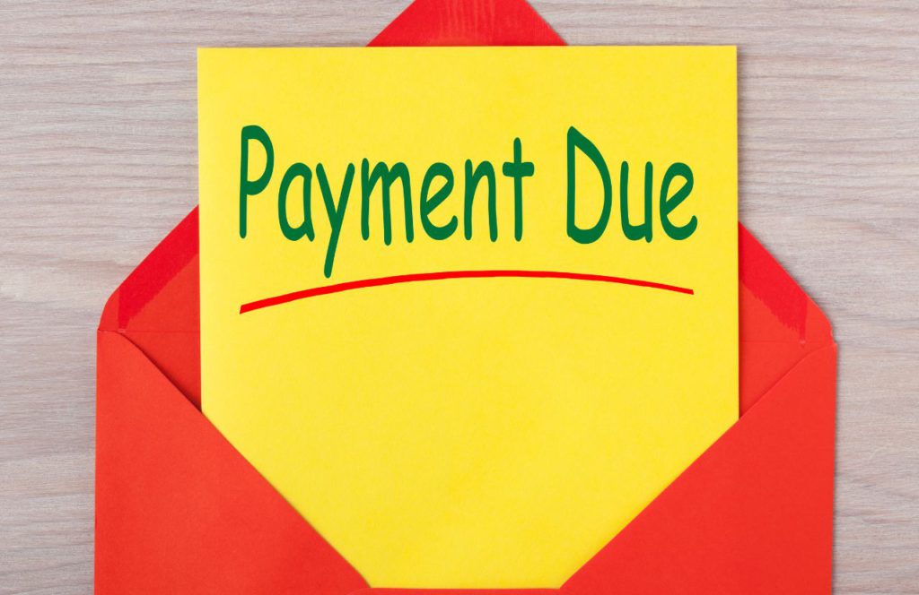 red envelope with a note inside that says tax resolution payment is due